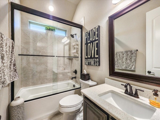 full bathroom with a textured wall, shower / bath combination with glass door, vanity, and toilet