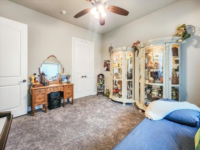 bedroom with a closet, a ceiling fan, and carpet flooring