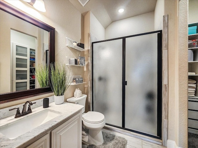 full bath with a stall shower, a textured wall, vanity, and toilet