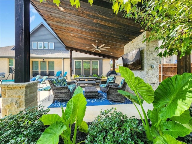 view of patio / terrace with fence, an outdoor living space, and a ceiling fan