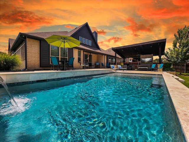 view of swimming pool featuring fence, a fenced in pool, and a patio