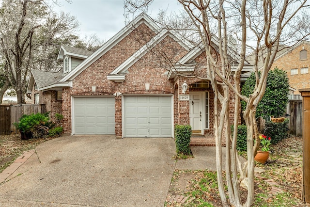 view of front of home featuring brick siding, roof with shingles, concrete driveway, an attached garage, and fence