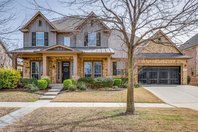 craftsman house with a garage, driveway, a standing seam roof, and board and batten siding