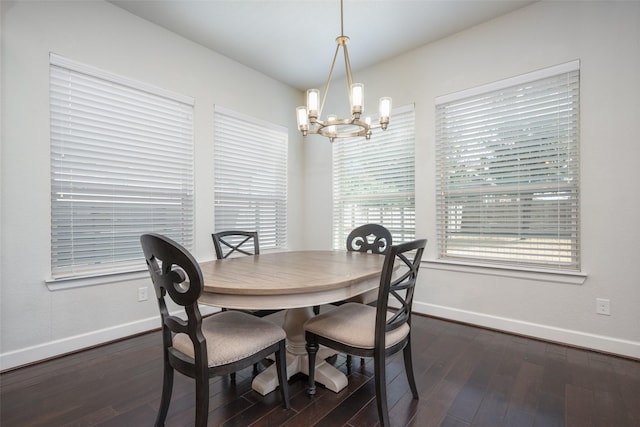 dining space with dark wood-style floors, baseboards, and a notable chandelier