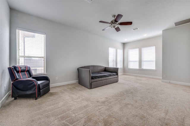 sitting room with carpet, visible vents, and baseboards