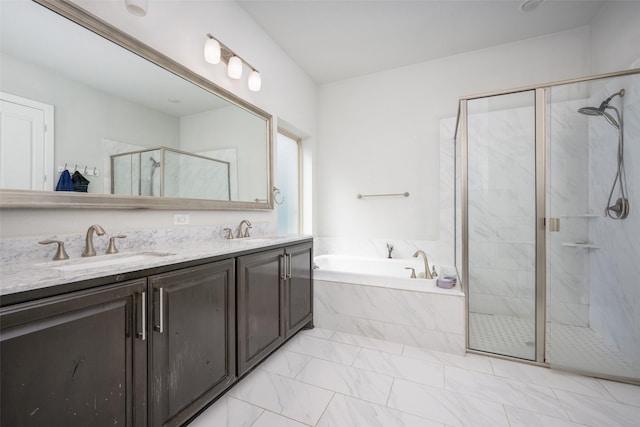 bathroom with a garden tub, double vanity, a sink, and a shower stall