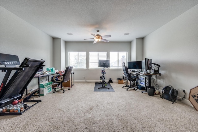 workout area with ceiling fan, a textured ceiling, carpet, and visible vents