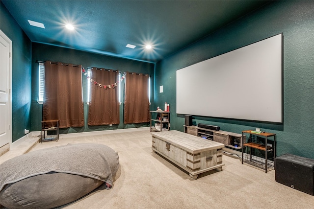 carpeted cinema room with recessed lighting