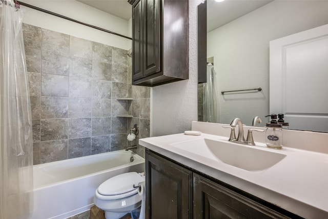 bathroom featuring toilet, a textured wall, shower / tub combo with curtain, and vanity