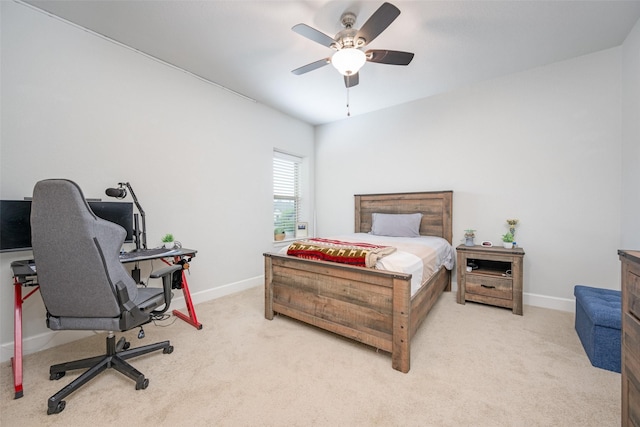 bedroom featuring ceiling fan, light carpet, and baseboards