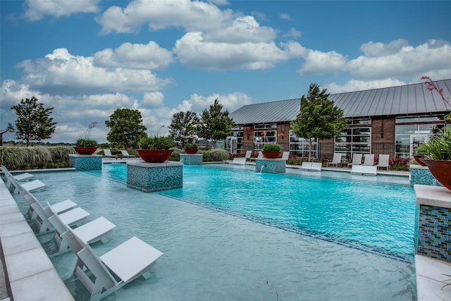 community pool featuring a patio and fence