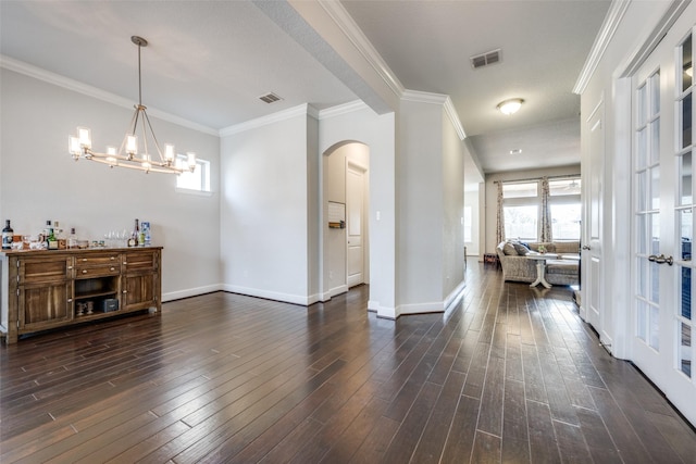 foyer entrance featuring baseboards, crown molding, visible vents, and dark wood-style flooring