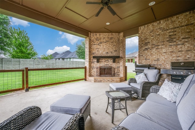 view of patio / terrace with a grill, ceiling fan, an outdoor living space with a fireplace, and a fenced backyard