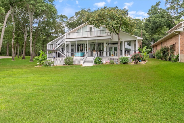 view of front of property featuring a front lawn, stairway, and a porch