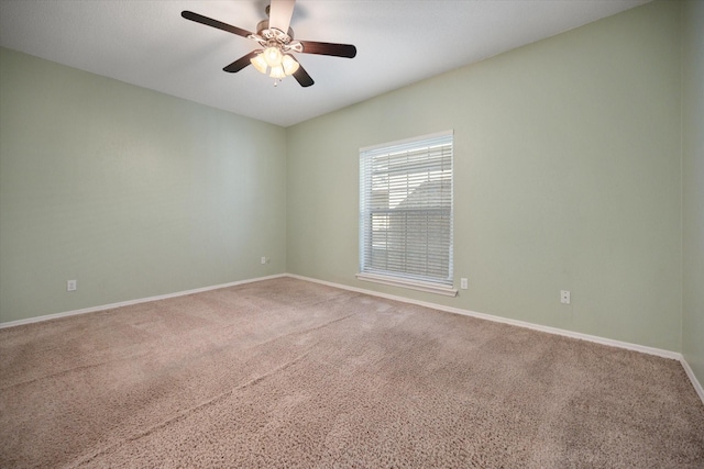 unfurnished room featuring a ceiling fan, carpet floors, and baseboards