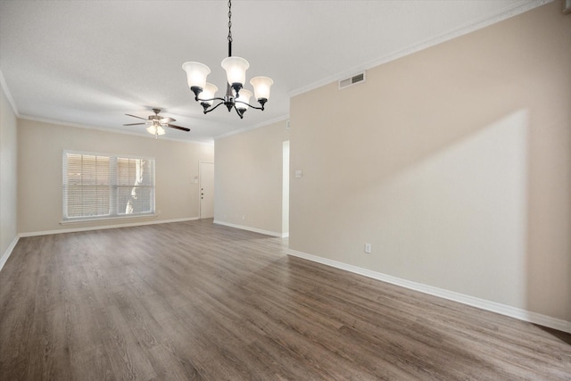 spare room featuring baseboards, crown molding, visible vents, and wood finished floors