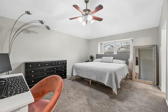 bedroom featuring carpet floors, a ceiling fan, vaulted ceiling, and a textured ceiling