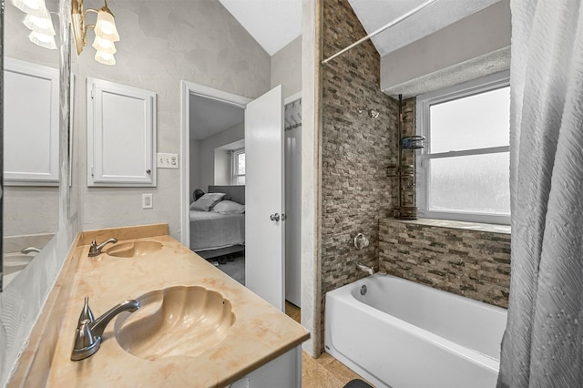 full bathroom featuring a chandelier, double vanity, bathtub / shower combination, and a sink