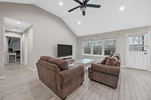 living room featuring a healthy amount of sunlight, light wood finished floors, and a ceiling fan