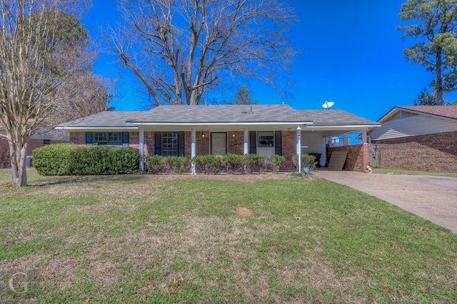 ranch-style home featuring brick siding, a front yard, a carport, and concrete driveway