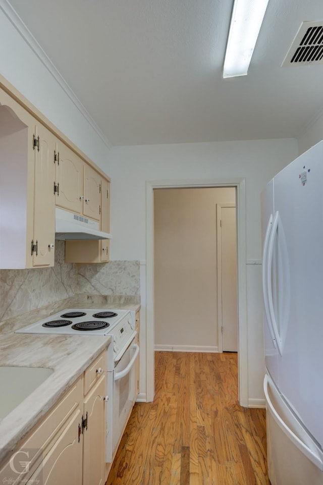 kitchen featuring white appliances, light wood finished floors, visible vents, light countertops, and under cabinet range hood