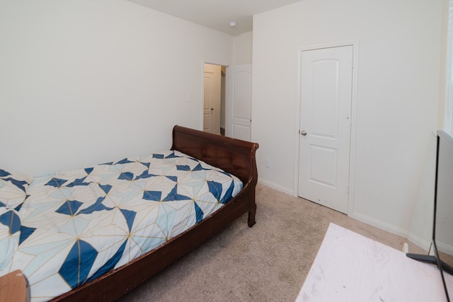 carpeted bedroom with baseboards