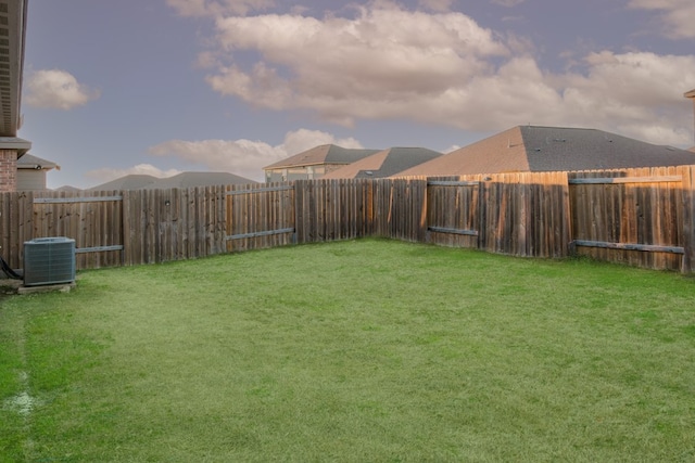 view of yard with a fenced backyard and cooling unit