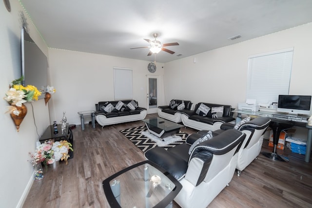 living room featuring a ceiling fan, baseboards, visible vents, and wood finished floors