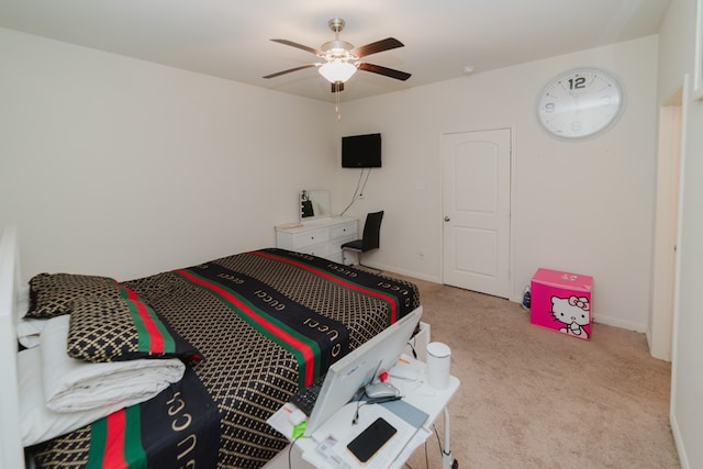 carpeted bedroom featuring ceiling fan and baseboards