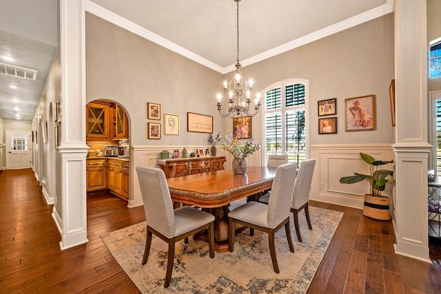 209 Chrissa Dr, Pottsboro, TX 75076 - dining room with dark wood finished floors, arched walkways, wainscoting, a decorative wall, and a chandelier