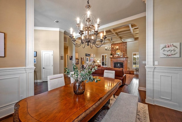 209 Chrissa Dr, Pottsboro, TX 75076 - dining space with coffered ceiling, a chandelier, dark wood-type flooring, crown molding, and a brick fireplace