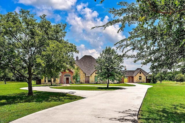 209 Chrissa Dr, Pottsboro, TX 75076 - view of front of house featuring curved driveway, a front yard, and stone siding