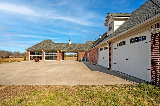 view of property exterior featuring a garage and brick siding