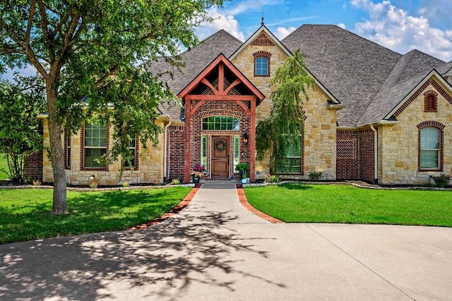 209 Chrissa Dr, Pottsboro, TX 75076 - view of front of home with stone siding, a shingled roof, and a front lawn