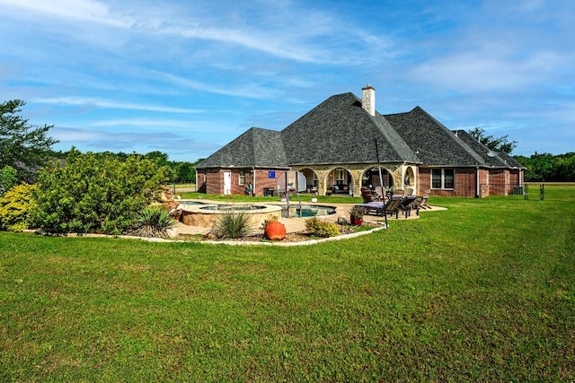 209 Chrissa Dr, Pottsboro, TX 75076 - rear view of house with an in-ground hot tub, a yard, a patio area, a chimney, and brick siding
