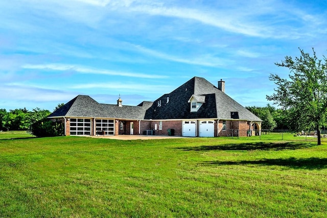209 Chrissa Dr, Pottsboro, TX 75076 - back of house with brick siding, a chimney, a garage, and driveway