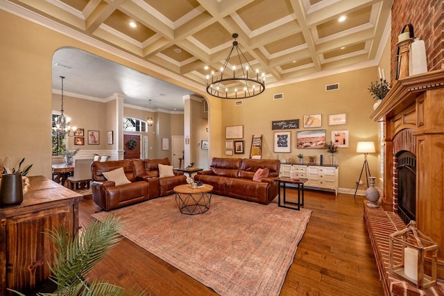209 Chrissa Dr, Pottsboro, TX 75076 - living room with arched walkways, a chandelier, crown molding, coffered ceiling, and beamed ceiling