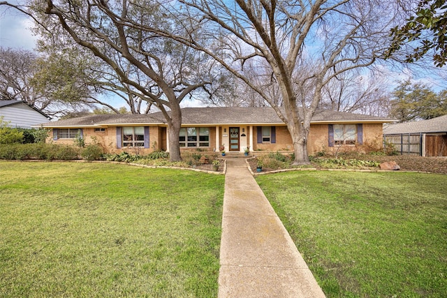 ranch-style house with brick siding and a front lawn