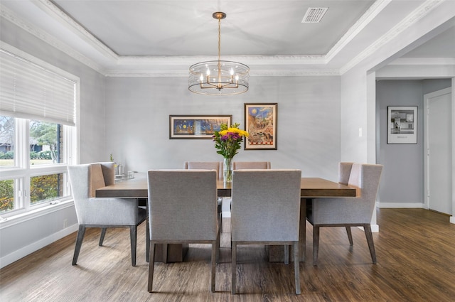 dining area featuring baseboards, visible vents, crown molding, and wood finished floors