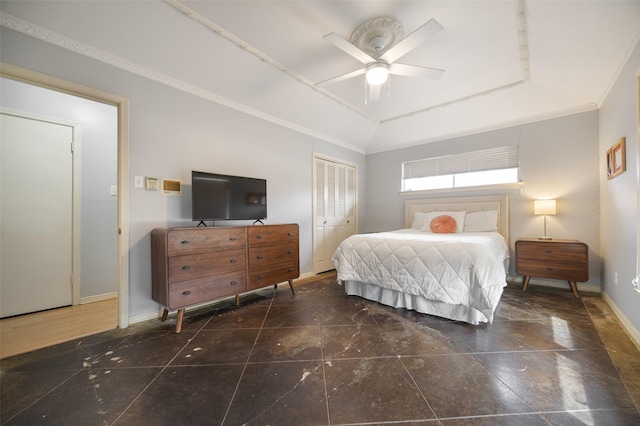 bedroom with baseboards, ceiling fan, vaulted ceiling, crown molding, and a closet