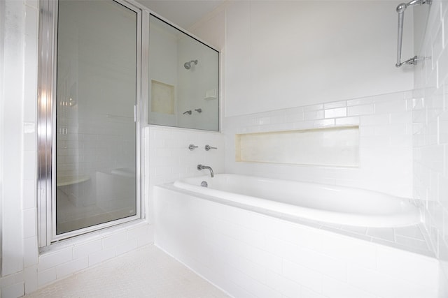 bathroom featuring a stall shower and a garden tub