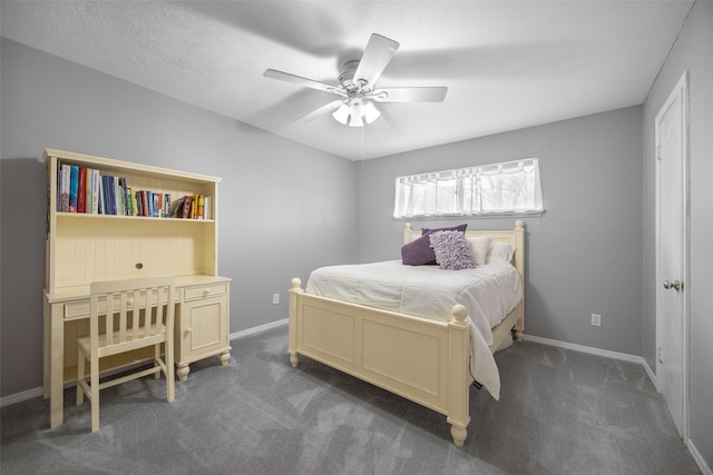 bedroom with ceiling fan, dark colored carpet, and baseboards