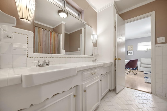 full bathroom with double vanity, ornamental molding, backsplash, tile patterned floors, and a sink