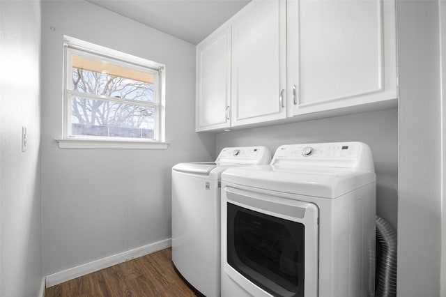 washroom with dark wood-type flooring, cabinet space, baseboards, and separate washer and dryer