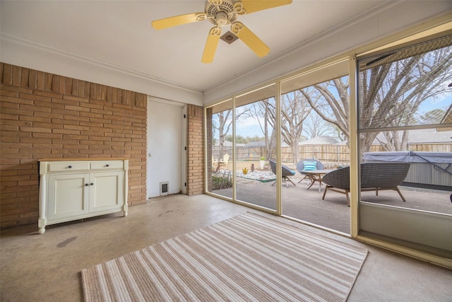 unfurnished sunroom with ceiling fan and visible vents