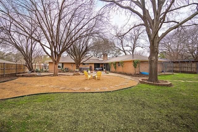 view of yard with a fenced backyard and a patio