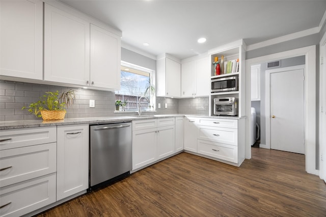 kitchen with dark wood-style floors, visible vents, appliances with stainless steel finishes, white cabinets, and a sink