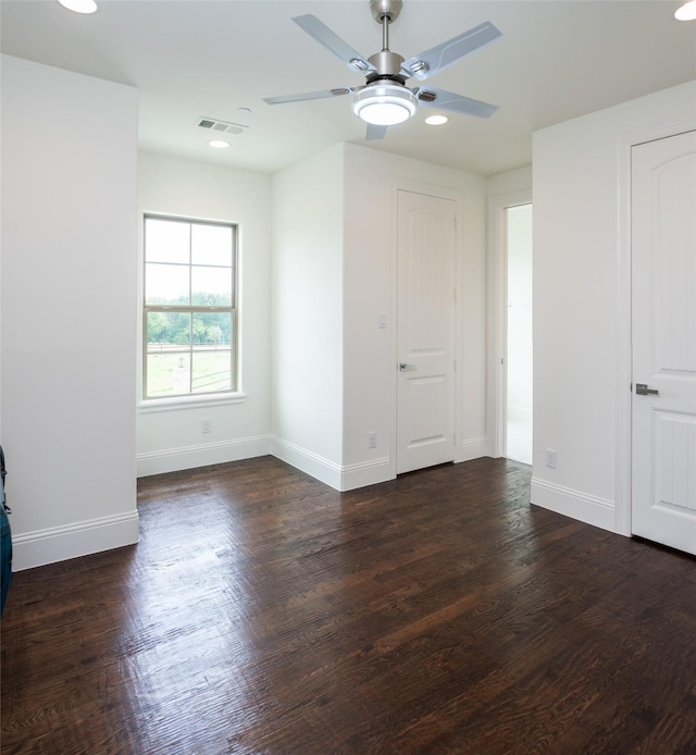 empty room with recessed lighting, wood finished floors, a ceiling fan, visible vents, and baseboards