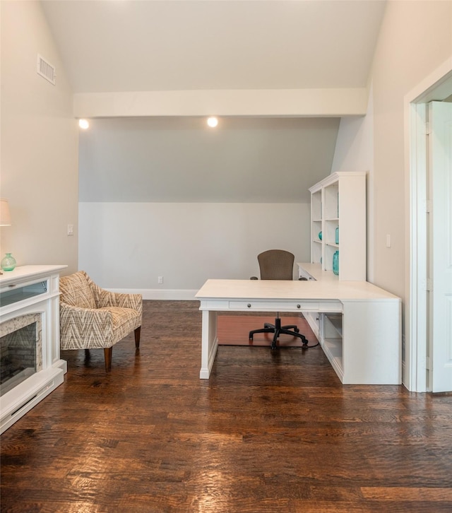 office featuring dark wood-style floors, lofted ceiling, visible vents, a premium fireplace, and baseboards