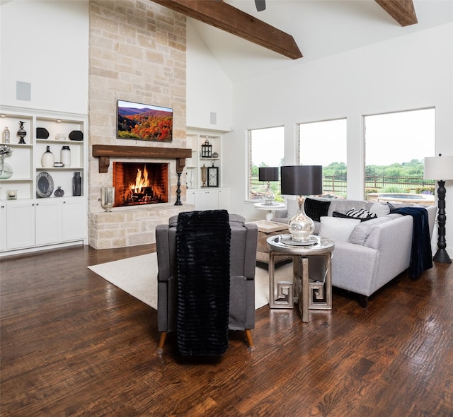 living room featuring dark wood-style floors, a wealth of natural light, high vaulted ceiling, and a stone fireplace